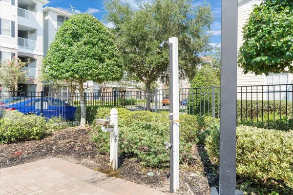 a view of a patio with a dining table and chairs with wooden floor and fence