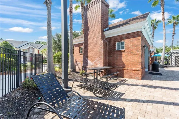 a view of a house with pool and sitting area