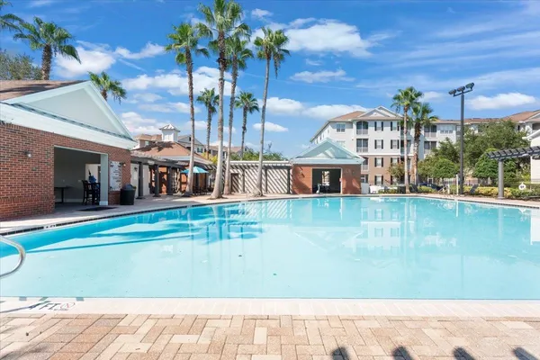 a view of swimming pool with outdoor seating and plants
