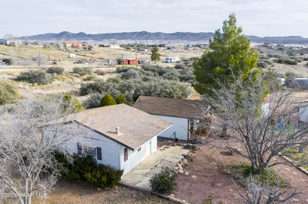 an aerial view of residential houses with outdoor space and seating