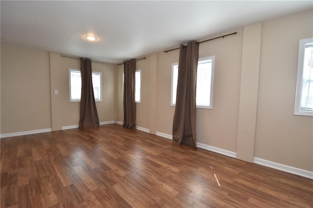 5470 Library Road Bethel Park, PA 15102 - Photo 12 of 24 an empty room with wooden floor and windows