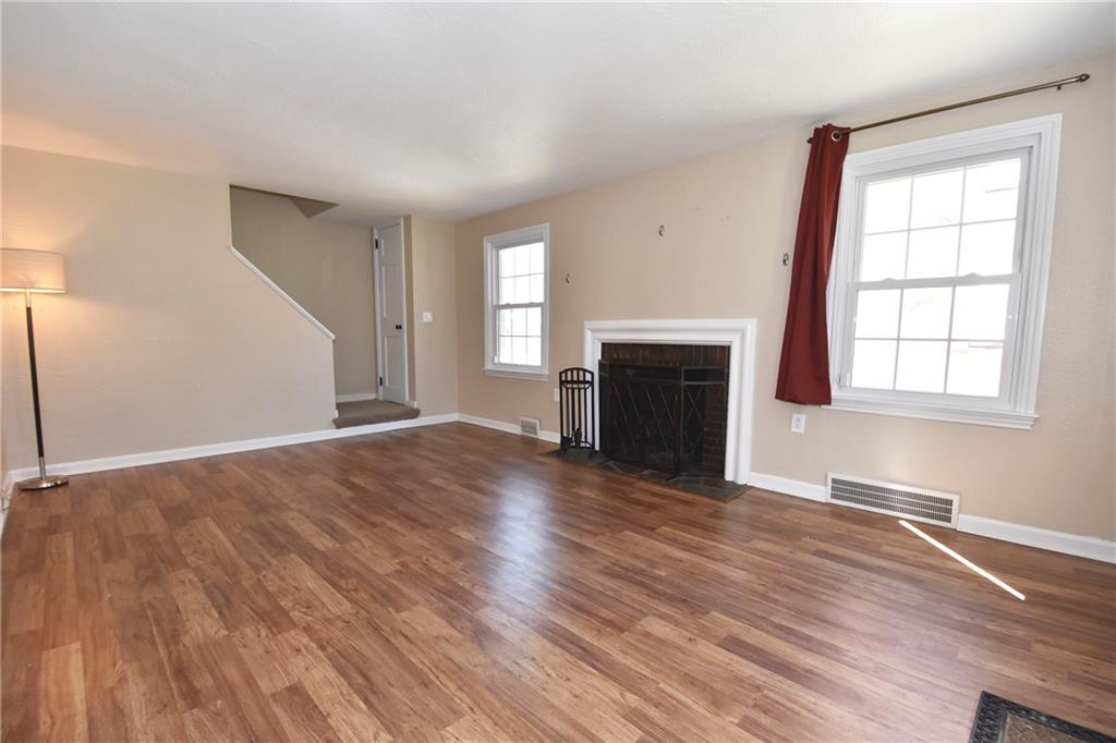 5470 Library Road Bethel Park, PA 15102 - Photo 3 of 24 an empty room with wooden floor fireplace and windows
