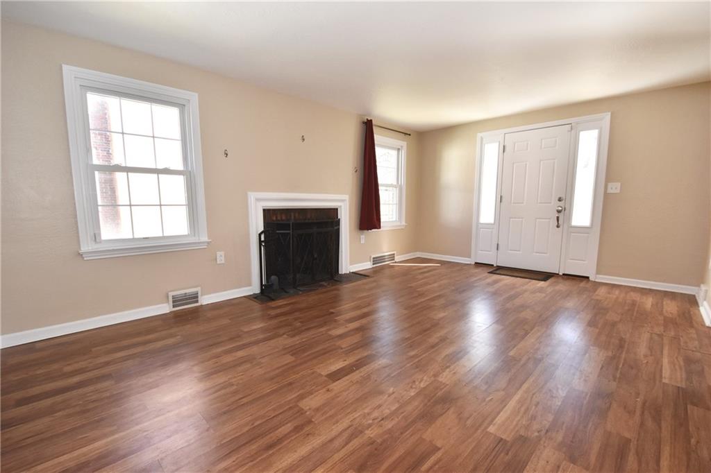5470 Library Road Bethel Park, PA 15102 - Photo 4 of 24 an empty room with wooden floor and windows