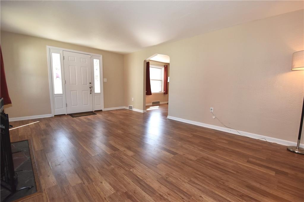 5470 Library Road Bethel Park, PA 15102 - Photo 5 of 24 a view of an empty room with wooden floor and a window