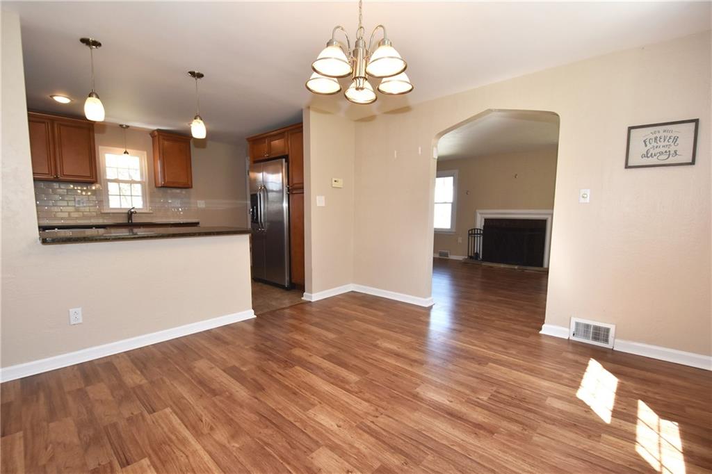 5470 Library Road Bethel Park, PA 15102 - Photo 7 of 24 a view of a kitchen with a dishwasher cabinets and wooden floor