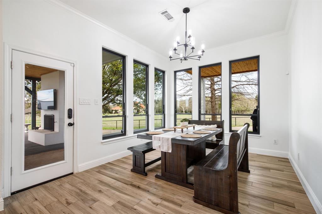 245 Barnes Bridge Road Sunnyvale, TX 75182 - Photo 15 of 40 The charming breakfast area offers a picturesque backdrop for slow mornings and quiet reflection.