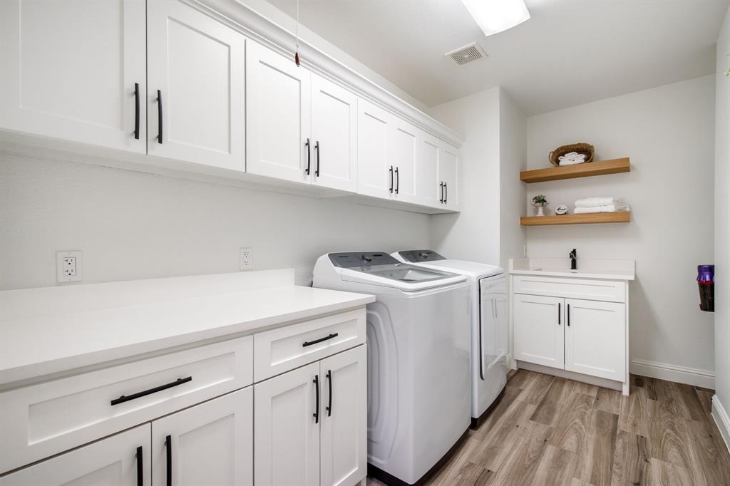245 Barnes Bridge Road Sunnyvale, TX 75182 - Photo 18 of 40 Laundry room featuring unlimited storage, washer and dryer hook ups (washer and dryer not included) and a sink. This room is conveniently located between the garage entry and kitchen. There's a laundry chute!
