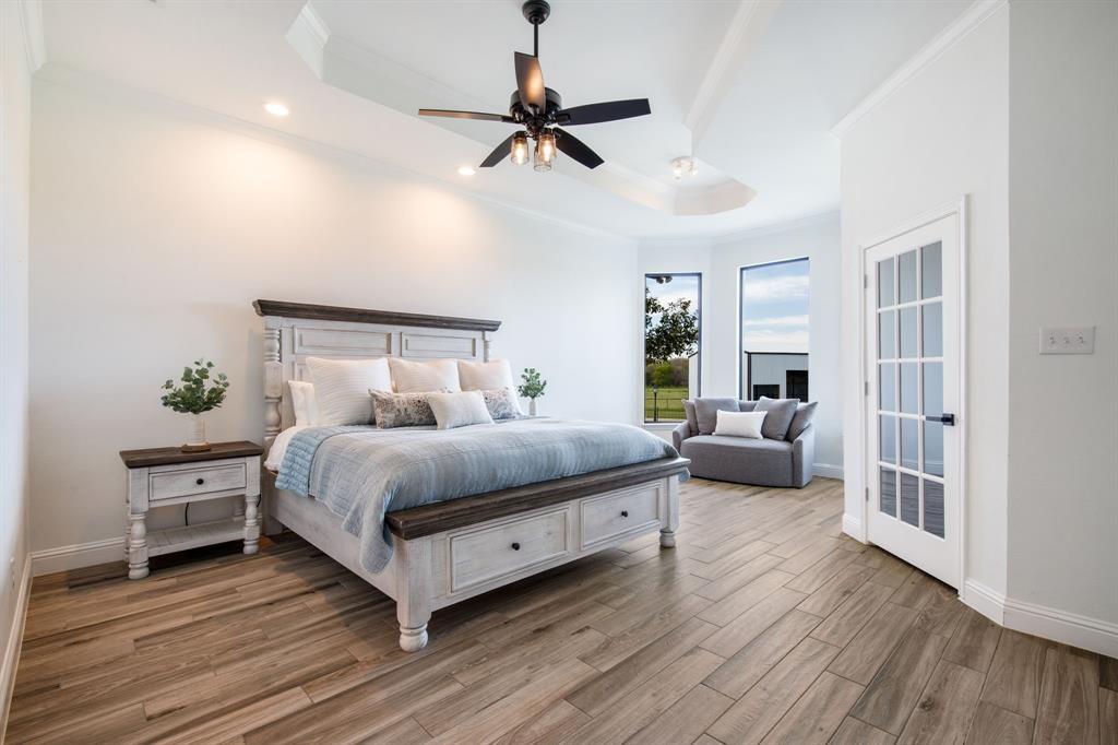 245 Barnes Bridge Road Sunnyvale, TX 75182 - Photo 19 of 40 The expansive primary suite features a dedicated sitting area and a versatile secondary space, perfect for a private office, craft room or flexible bonus room.