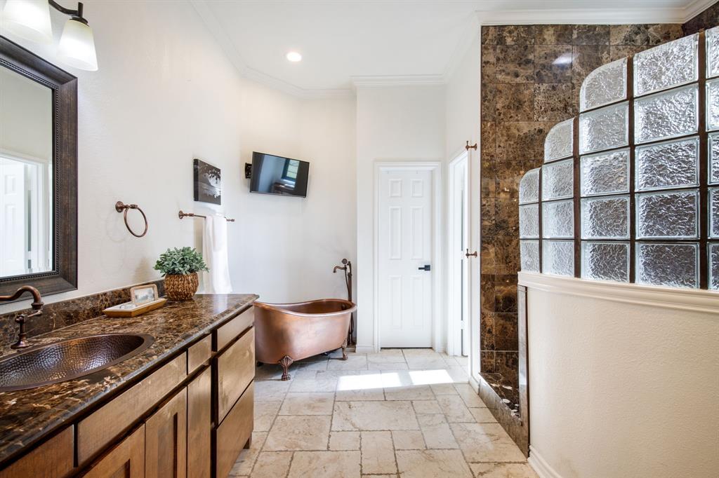 245 Barnes Bridge Road Sunnyvale, TX 75182 - Photo 23 of 40 Spacious primary suite bath. A walk-in closet lies behind the door.