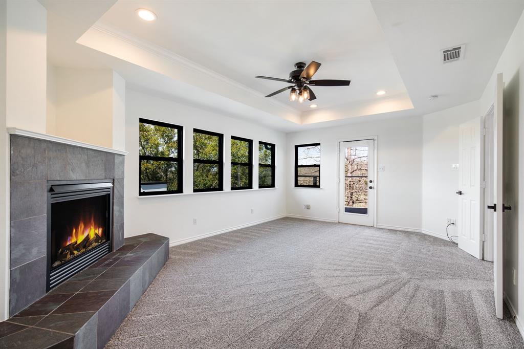 245 Barnes Bridge Road Sunnyvale, TX 75182 - Photo 27 of 40 Retreat to the third upstairs bedroom, where you can unwind by the glow of the fireplace or step through private double doors to enjoy sweeping views of the acreage from the balcony.
