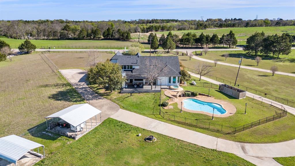 245 Barnes Bridge Road Sunnyvale, TX 75182 - Photo 37 of 40 The carport offers space for two additional parking spaces. A covered storage area lies just behind the carport.