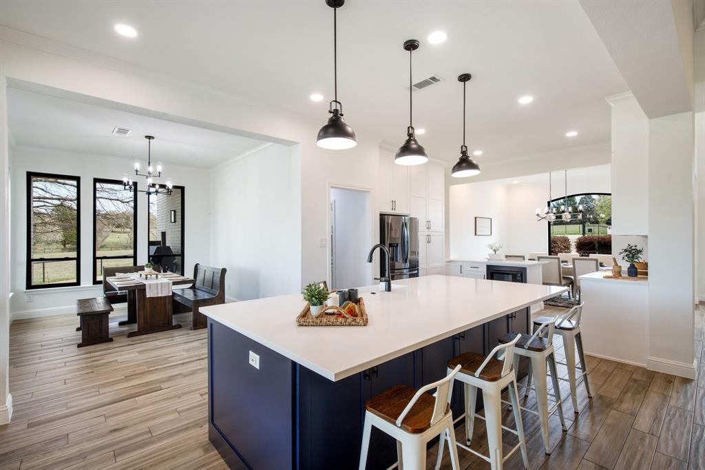 245 Barnes Bridge Road Sunnyvale, TX 75182 - Photo 10 of 40 Luxe quartz surface extends into an oversized eating area for 4, blending high-end style with everyday functionality.