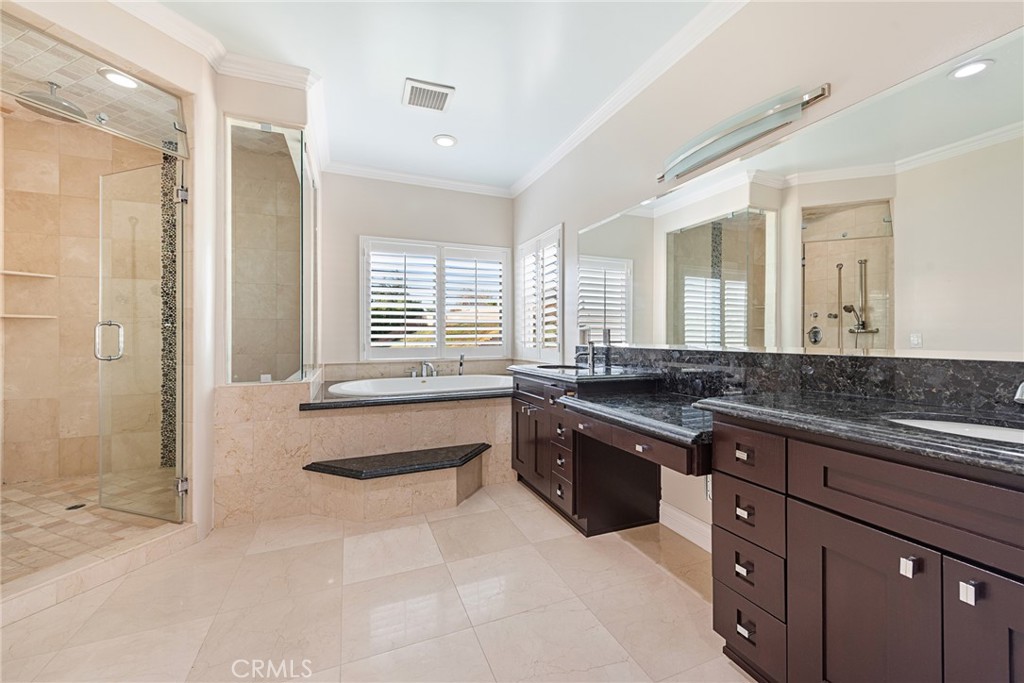 21819 Chestnut Court Walnut, CA 91789 - Photo 24 of 32 a spacious bathroom with a granite countertop tub sink and mirror