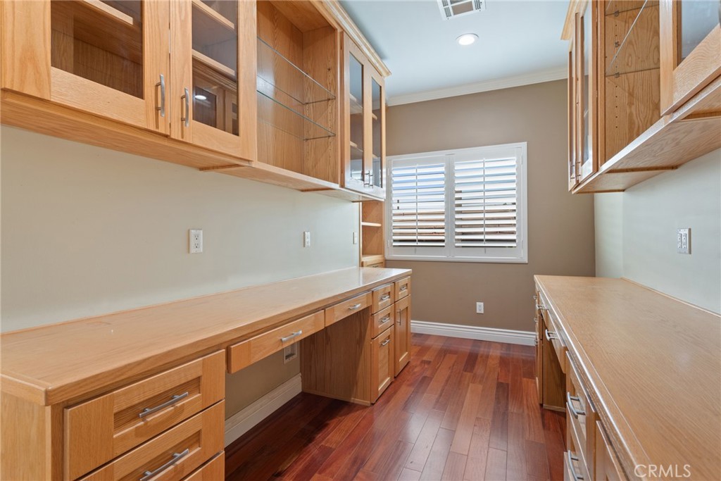 21819 Chestnut Court Walnut, CA 91789 - Photo 26 of 32 a kitchen with wooden floors and white cabinets