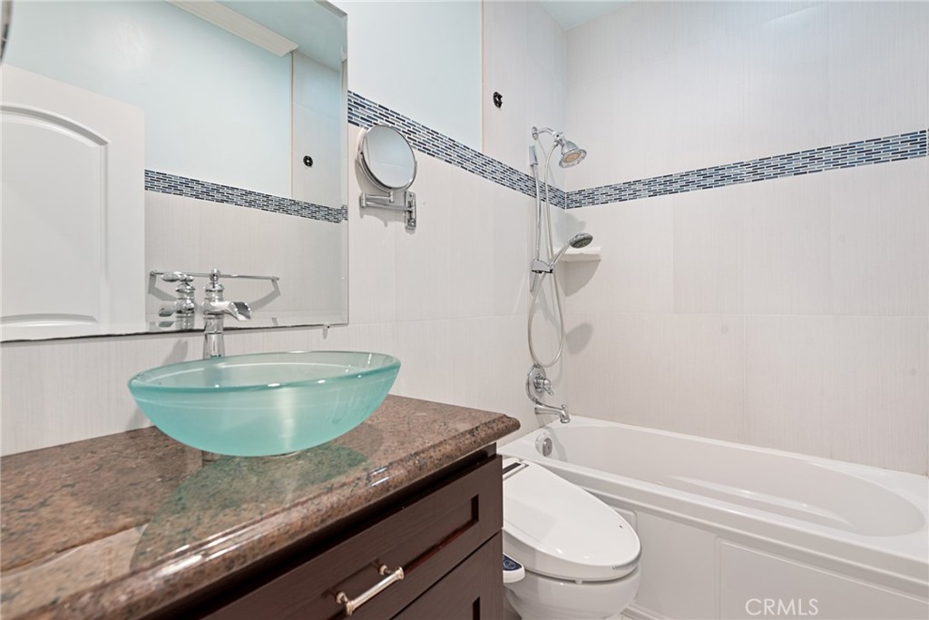 21819 Chestnut Court Walnut, CA 91789 - Photo 29 of 32 a bathroom with a granite countertop bathtub sink vanity mirror and toilet