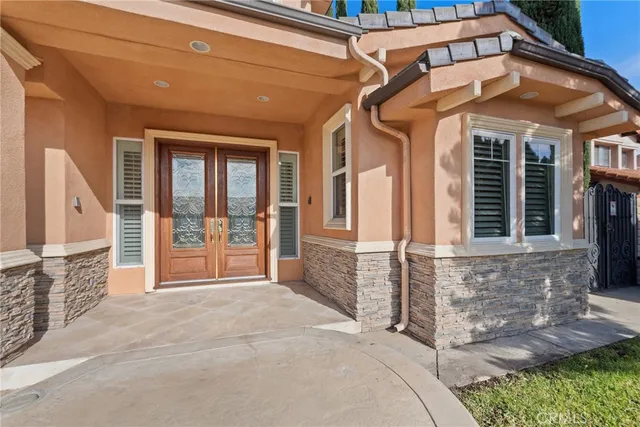 a view of a brick house with large windows