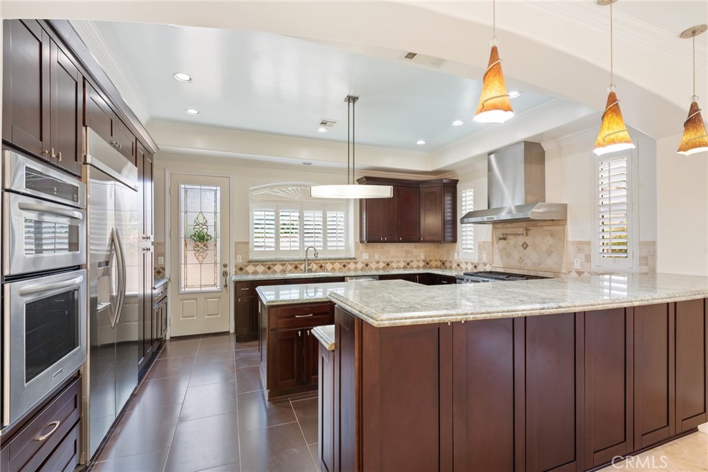21819 Chestnut Court Walnut, CA 91789 - Photo 7 of 32 a kitchen with stainless steel appliances granite countertop a sink a stove and a refrigerator