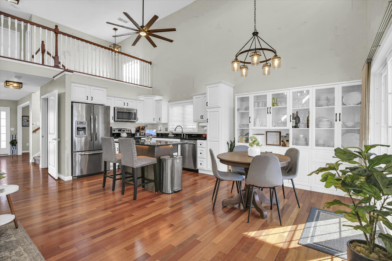 1315 West Ridge Lane Champaign, IL 61822 - Photo 38 of 102 a dining room with wooden floor a chandelier a wooden table and chairs