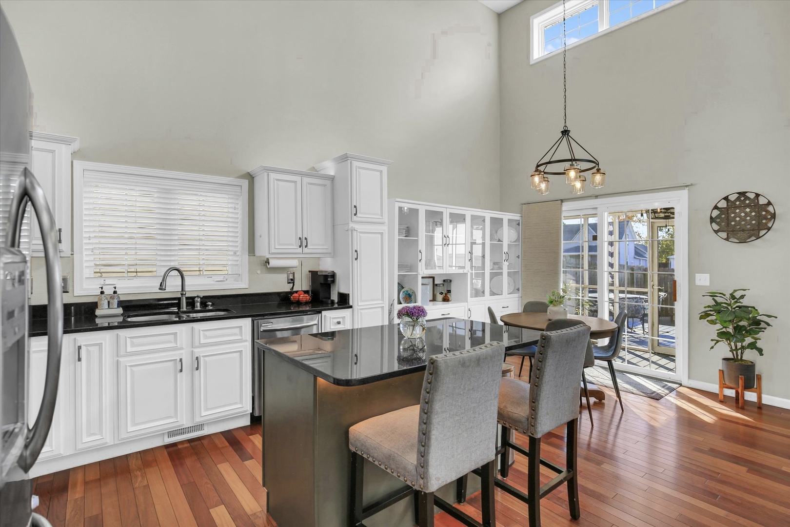 1315 West Ridge Lane Champaign, IL 61822 - Photo 53 of 102 a kitchen with granite countertop a table chairs stove and cabinets