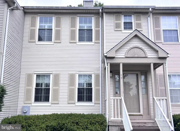 a view of a house with more windows and wooden fence