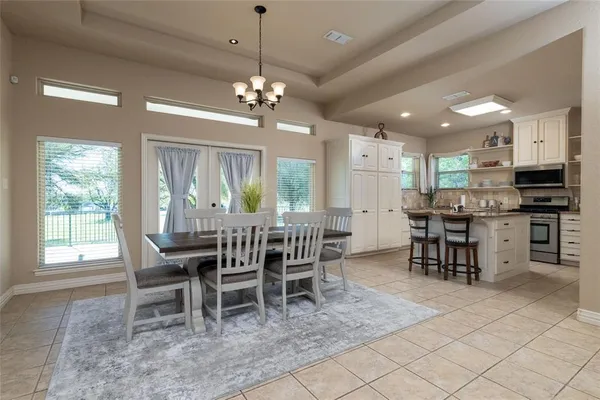 a kitchen with cabinets and chairs