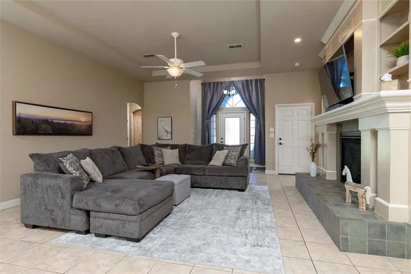 a living room with furniture and a chandelier