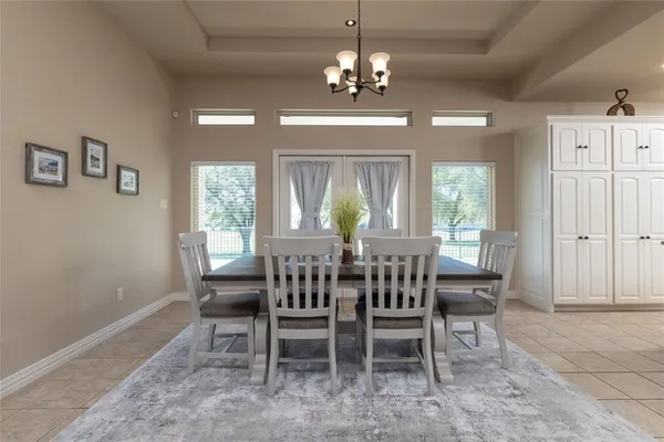 a view of a dining room with furniture and chandelier