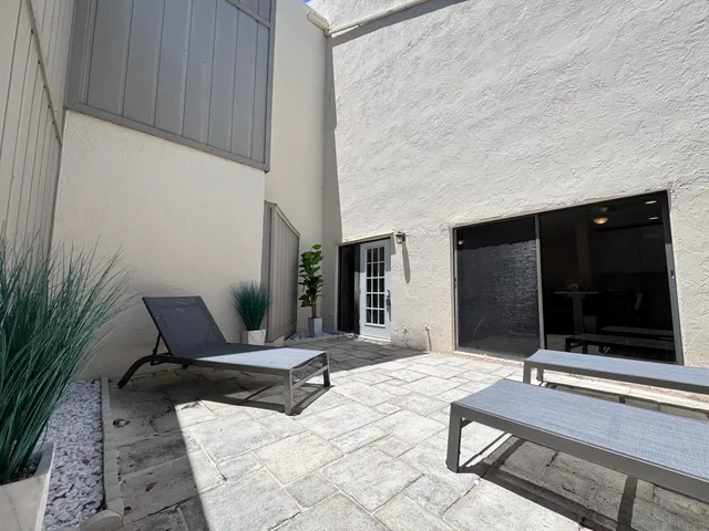 a building outdoor space with patio furniture and garden