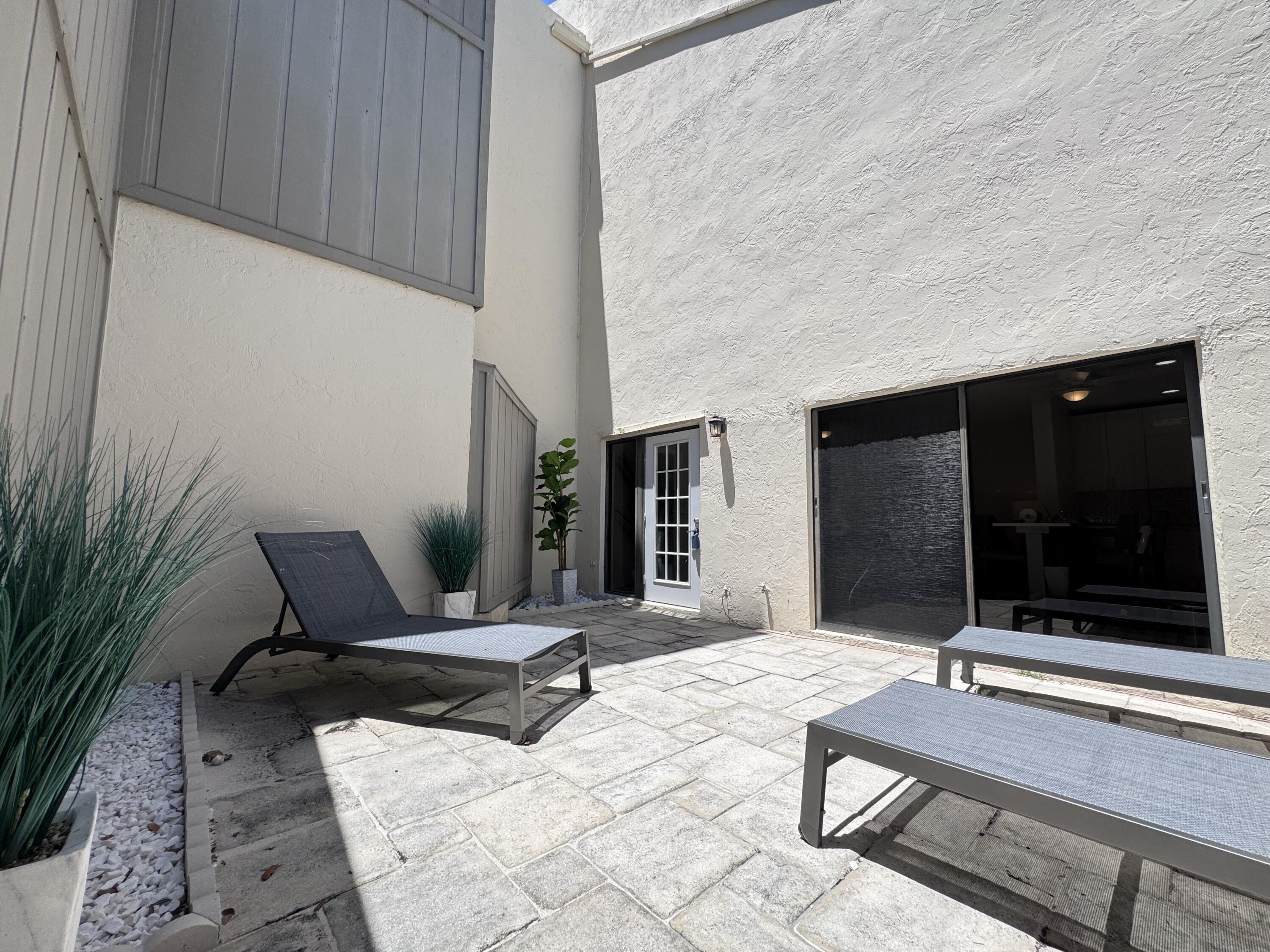 1605 Highway 1, Unit 1A Jupiter, FL 33477 - Photo 18 of 23 a building outdoor space with patio furniture and garden