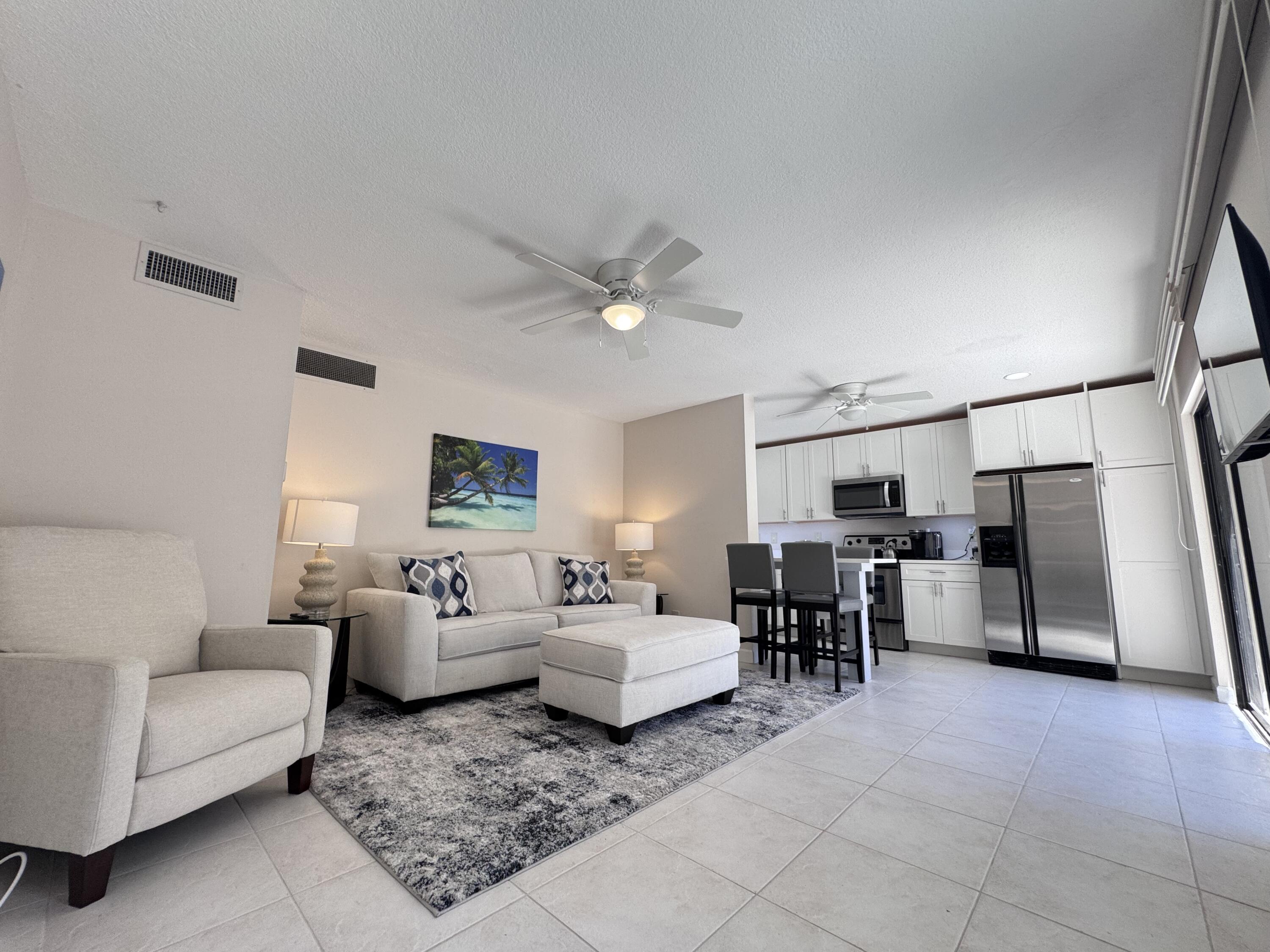1605 Highway 1, Unit 1A Jupiter, FL 33477 - Photo 3 of 23 a living room with furniture and a window