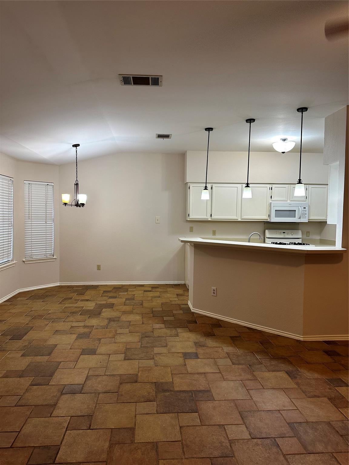 8007 Bounty Trail Austin, TX 78749 - Photo 17 of 32 Functional kitchen with ample cabinet space opens to the dining area featuring durable tile flooring.