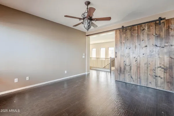 a view of a hallway with wooden floor and windows