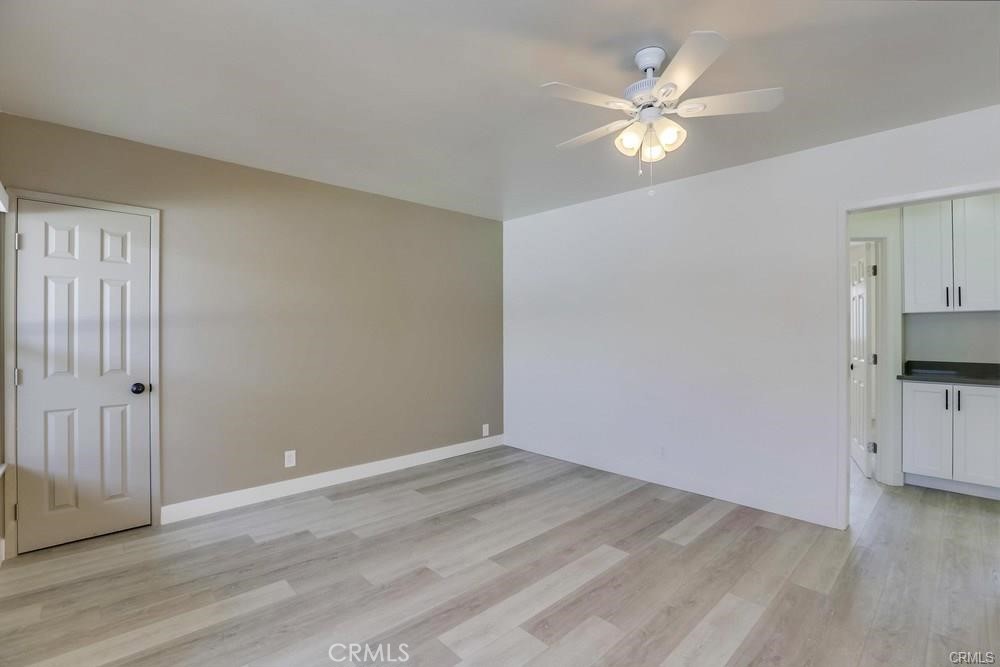 8716 Buckles Street Downey, CA 90241 - Photo 11 of 22 wooden floor in an empty room with a window