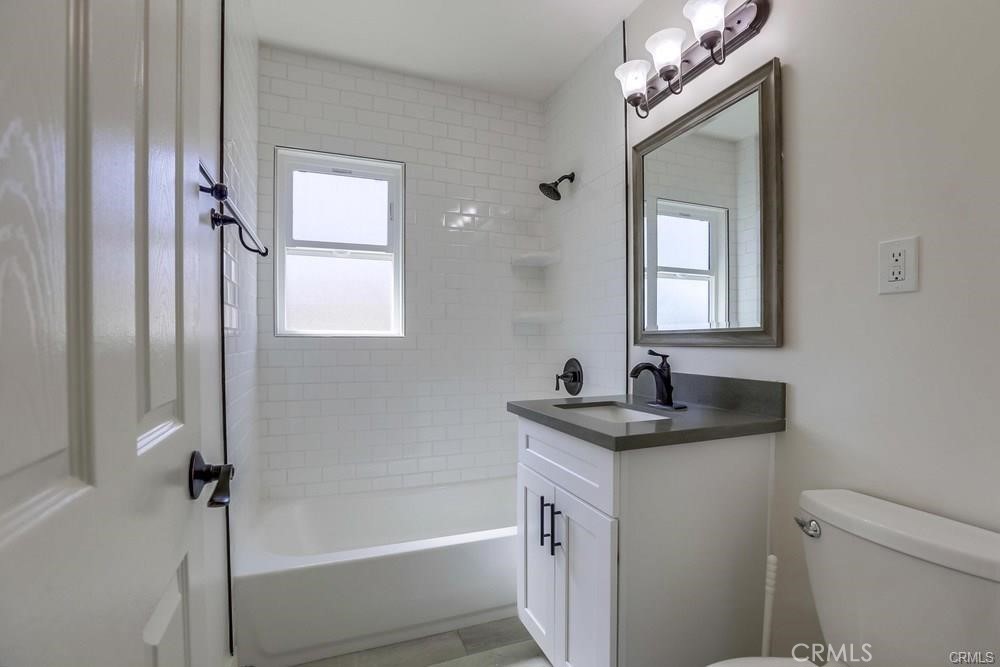 8716 Buckles Street Downey, CA 90241 - Photo 13 of 22 a bathroom with a granite countertop sink a toilet and shower