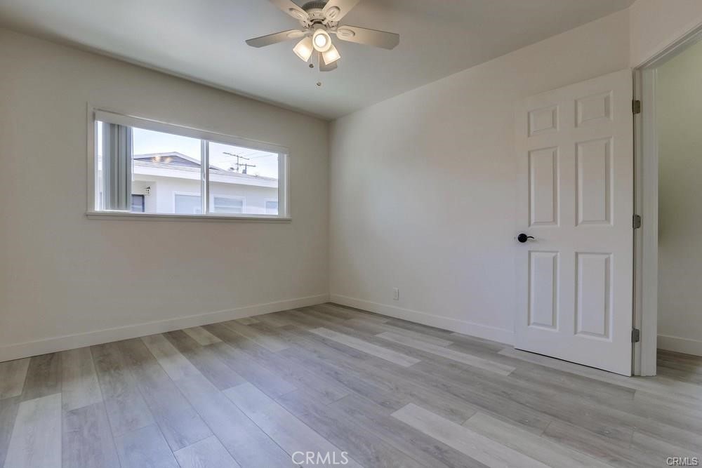 8716 Buckles Street Downey, CA 90241 - Photo 15 of 22 a view of an empty room with wooden floor and a window