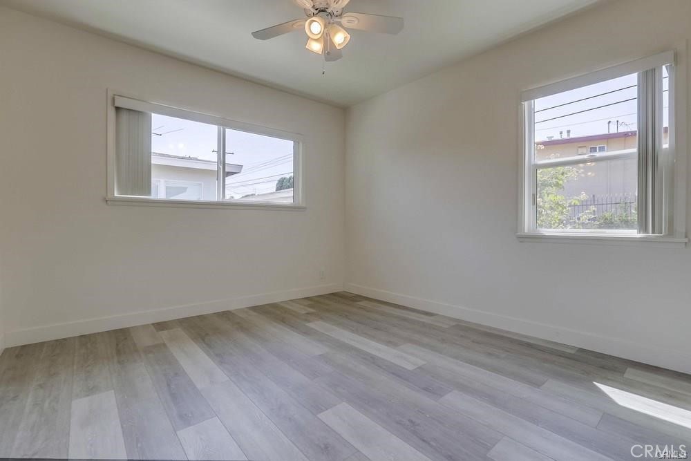 8716 Buckles Street Downey, CA 90241 - Photo 18 of 22 a view of an empty room with wooden floor and a window
