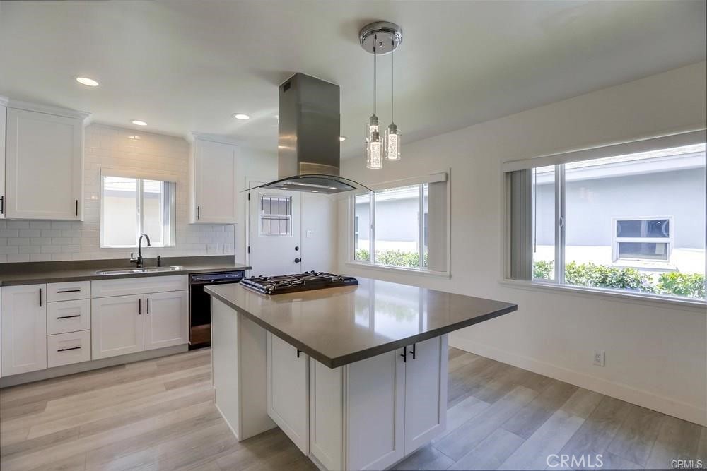 8716 Buckles Street Downey, CA 90241 - Photo 3 of 22 a kitchen with granite countertop a sink a counter space appliances and cabinets