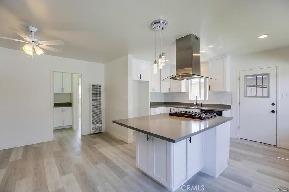 8716 Buckles Street Downey, CA 90241 - Photo 6 of 22 a kitchen with stainless steel appliances granite countertop a stove and a refrigerator