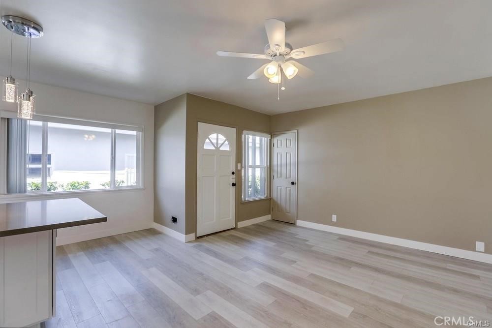 8716 Buckles Street Downey, CA 90241 - Photo 9 of 22 an empty room with wooden floor and windows