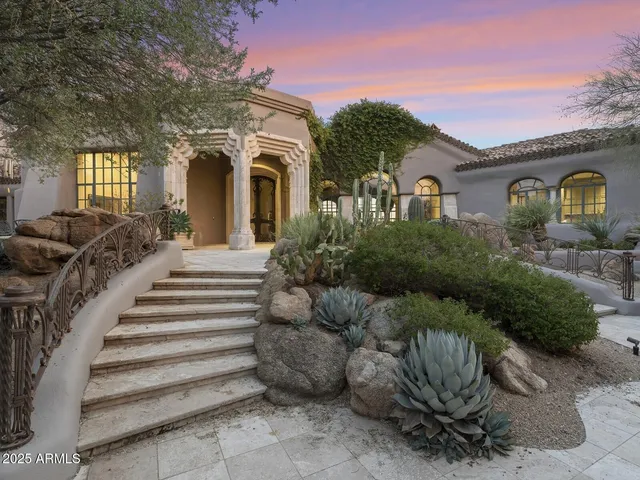 a living room with fireplace furniture and a rug