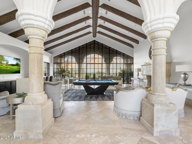 a living room with stainless steel appliances kitchen island granite countertop furniture and a flat screen tv