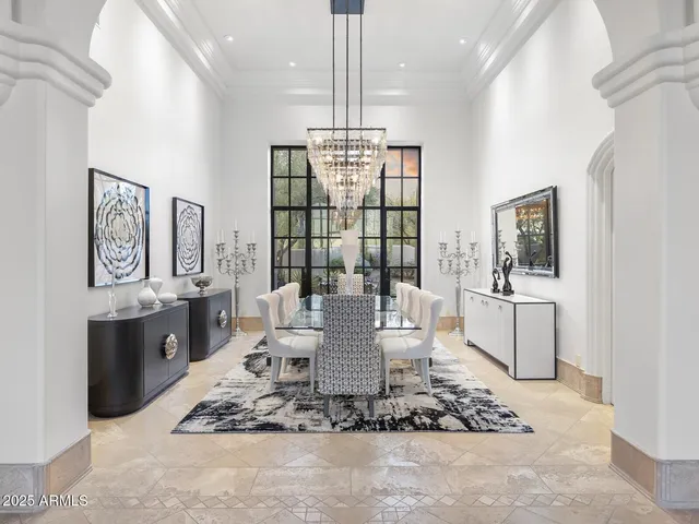 a living room with furniture a flat screen tv and a large window