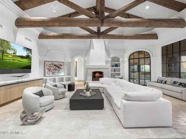 a living room with furniture a window and a flat screen tv