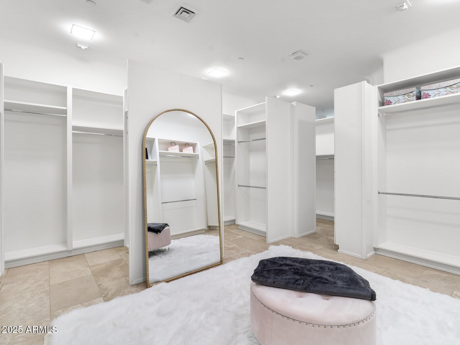 9422 East Happy Valley Road Scottsdale, AZ 85255 - Photo 38 of 78 a spacious bedroom with a bed a rug and a shower