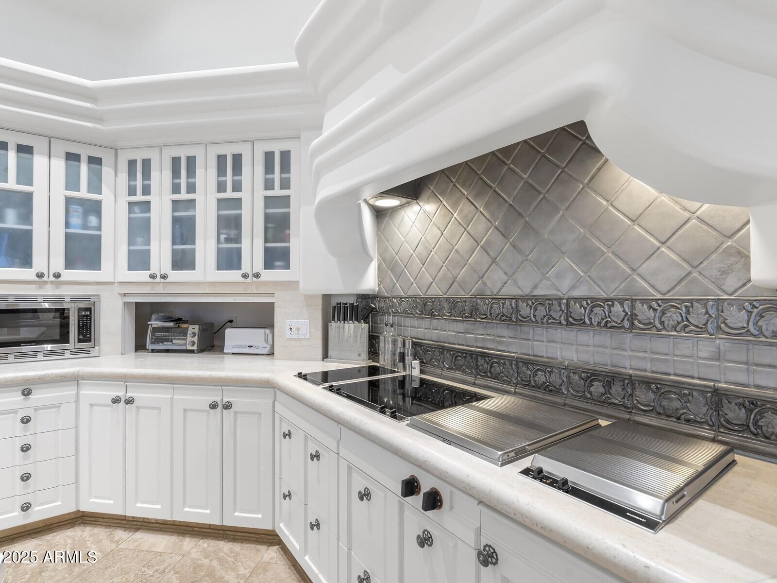 9422 East Happy Valley Road Scottsdale, AZ 85255 - Photo 40 of 99 a kitchen with granite countertop a sink and a stove
