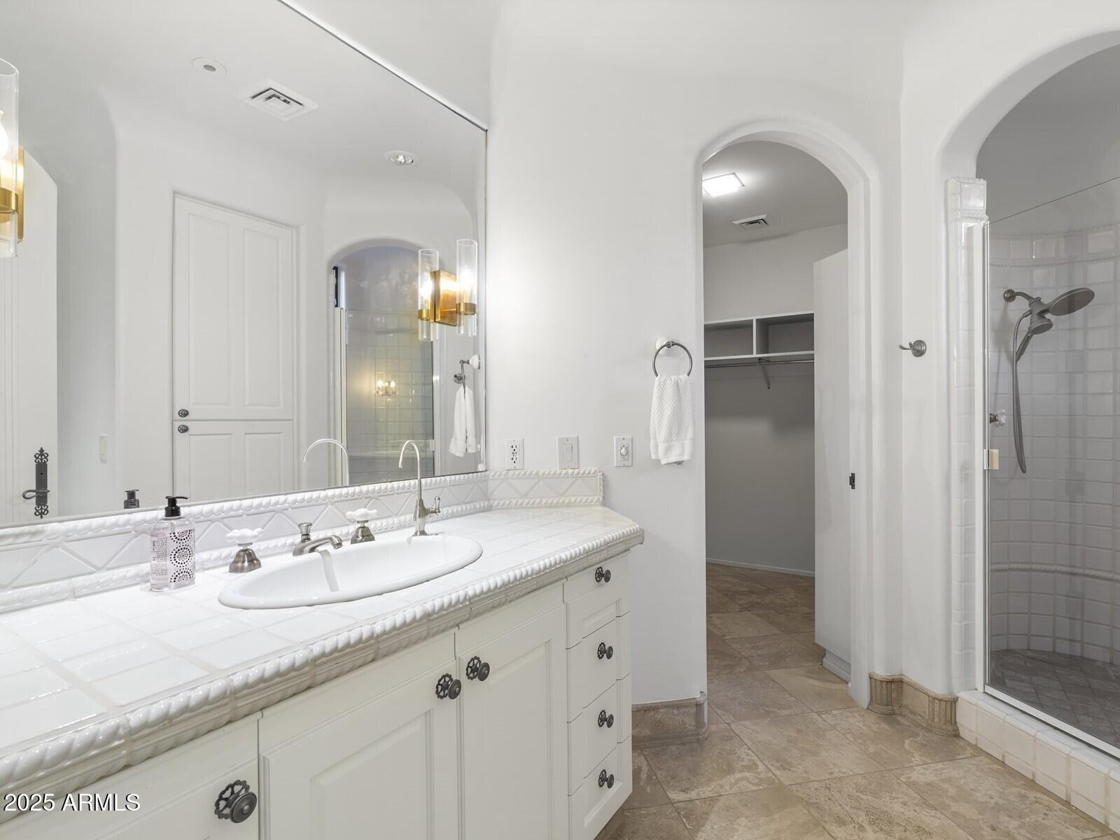 9422 East Happy Valley Road Scottsdale, AZ 85255 - Photo 42 of 78 a bathroom with a granite countertop sink and a mirror