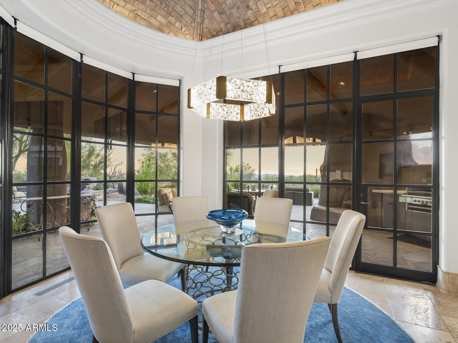 9422 East Happy Valley Road Scottsdale, AZ 85255 - Photo 44 of 99 a dining room with furniture window and wooden floor