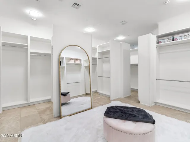 a living room with a large window and furniture