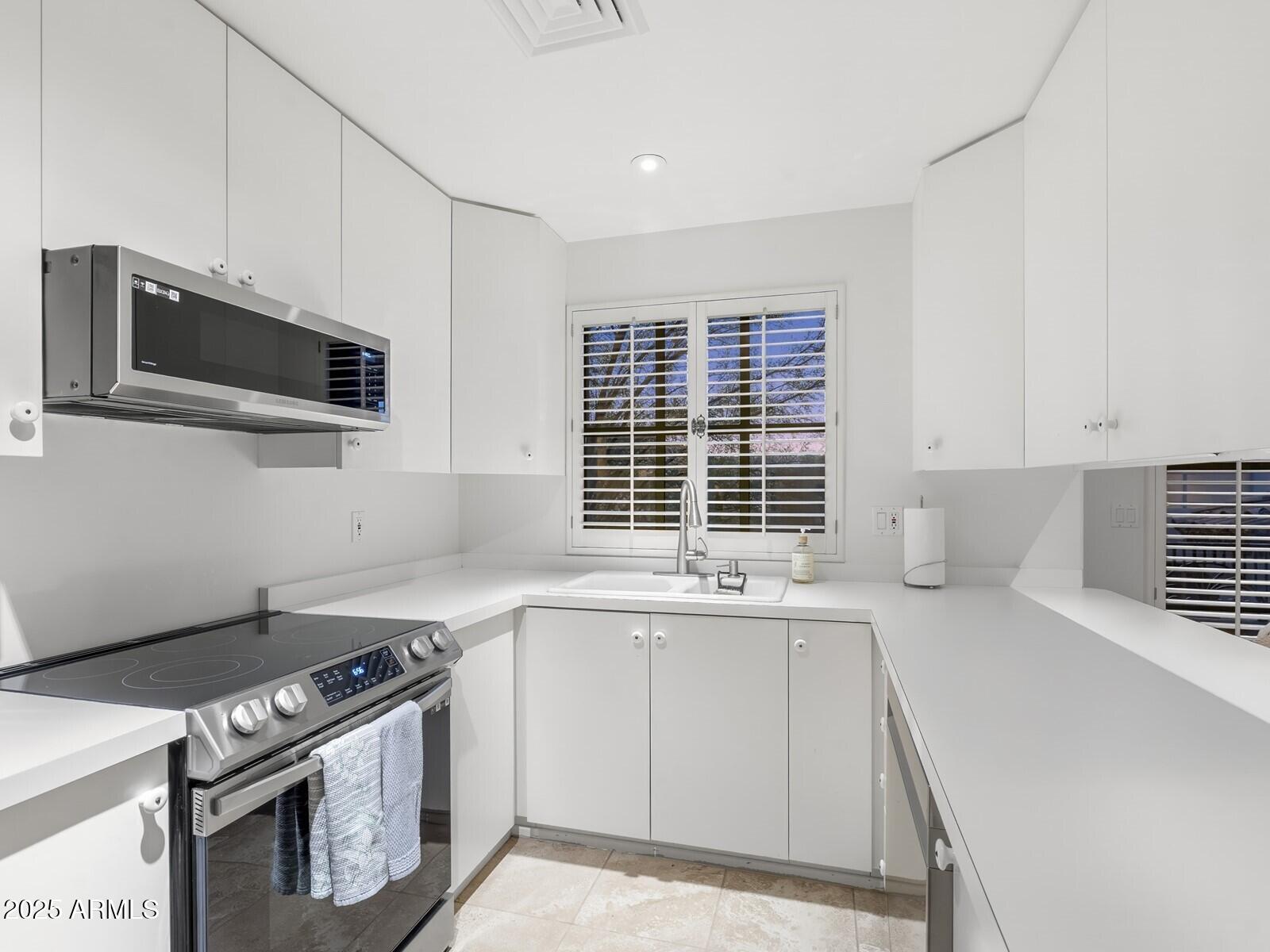 9422 East Happy Valley Road Scottsdale, AZ 85255 - Photo 69 of 78 White Cabinetry & Stainless Appliance