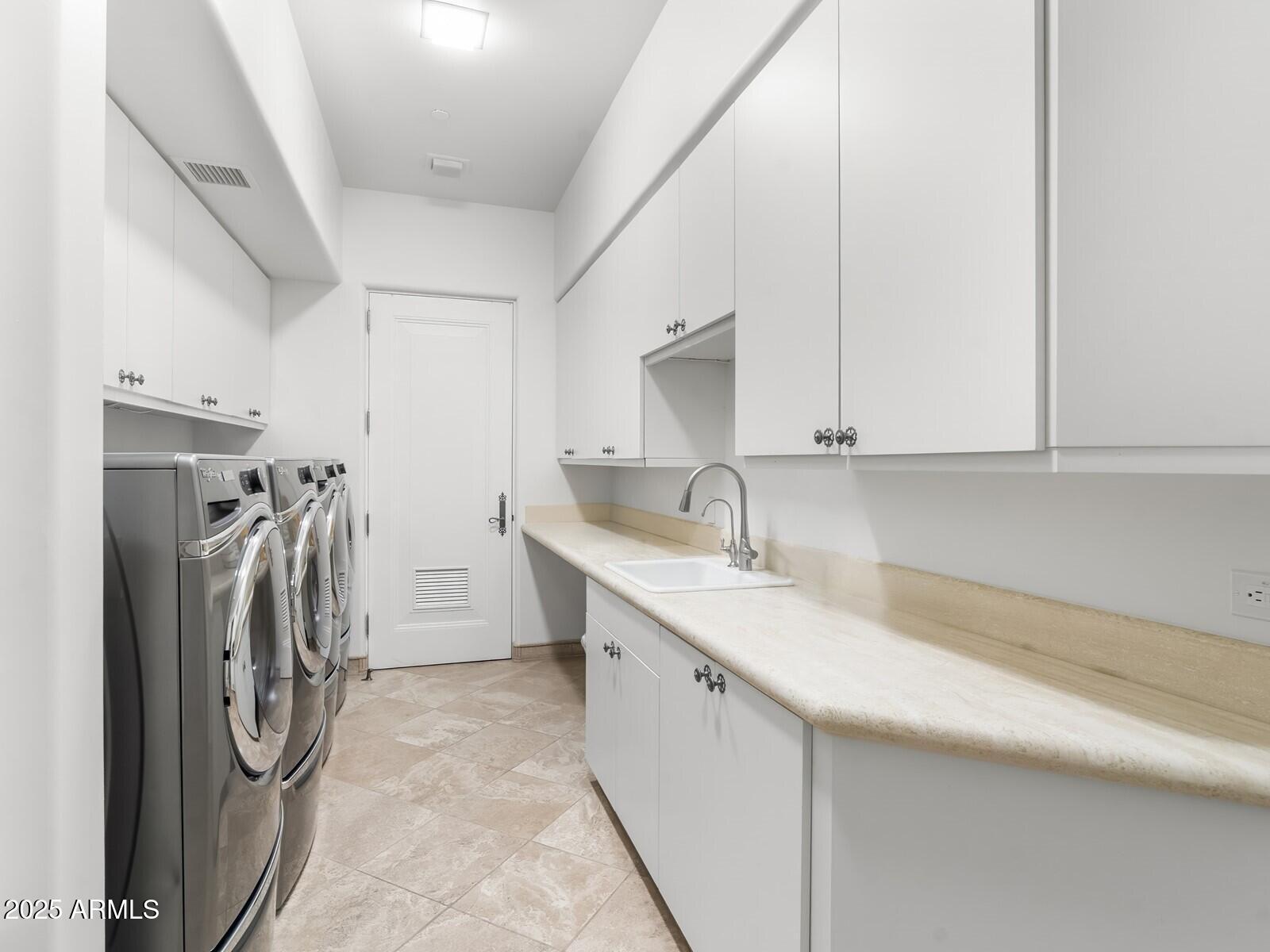 9422 East Happy Valley Road Scottsdale, AZ 85255 - Photo 70 of 99 a utility room with cabinets